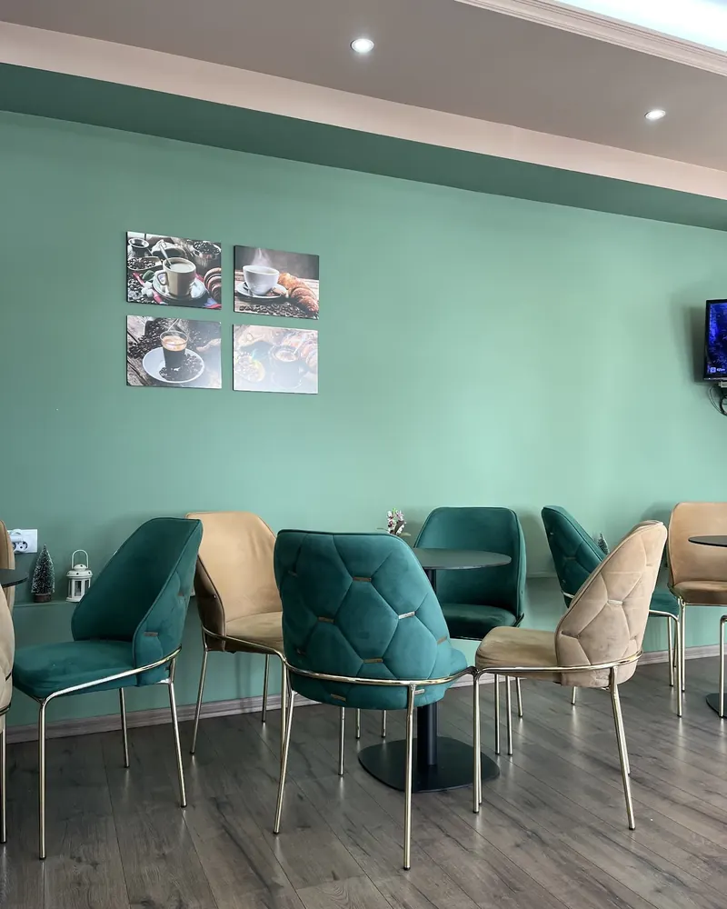 Inside Gold coffee shop: teal walls and velvet chairs