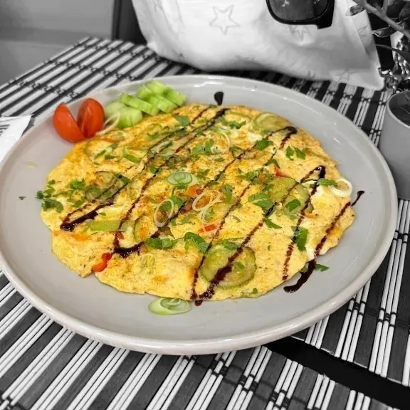 An omelette with peppers and spring onion